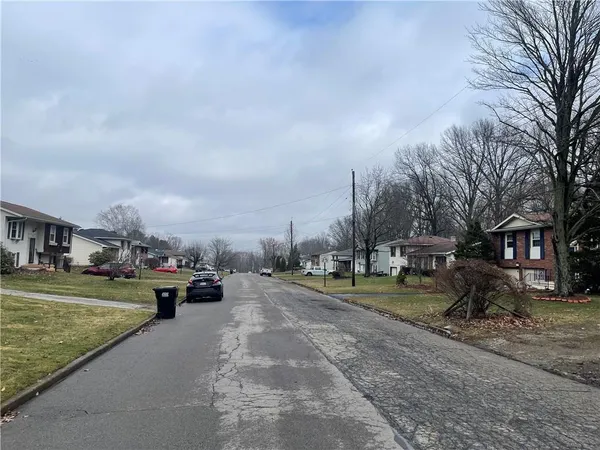a view of a park with cars parked