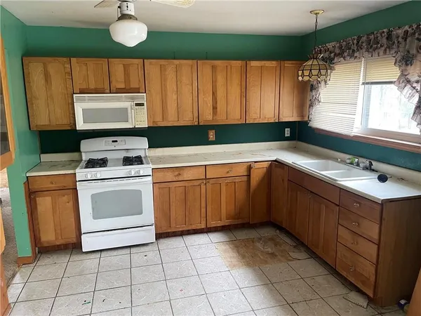a kitchen with a stove sink and cabinets