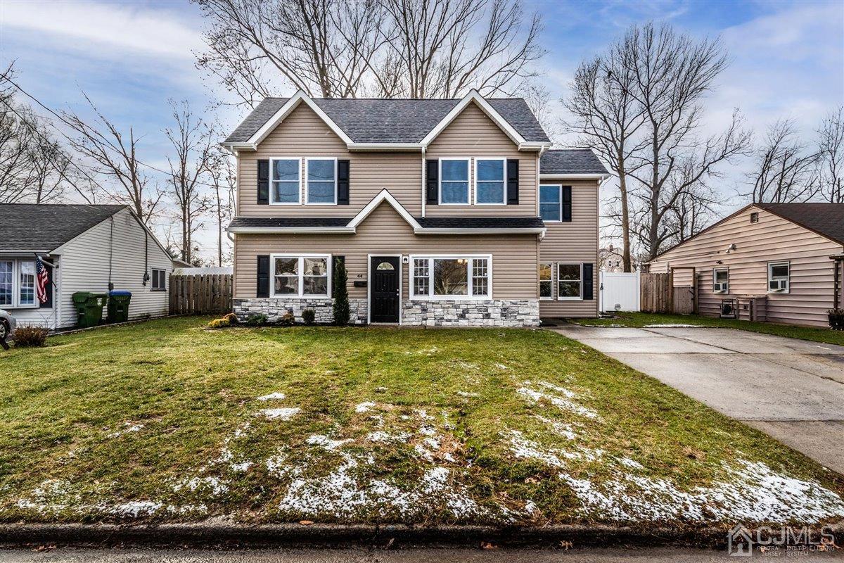 44 Rosewood Road Edison, NJ 08817 - Photo 1 of 33 a front view of a house with a garden and trees