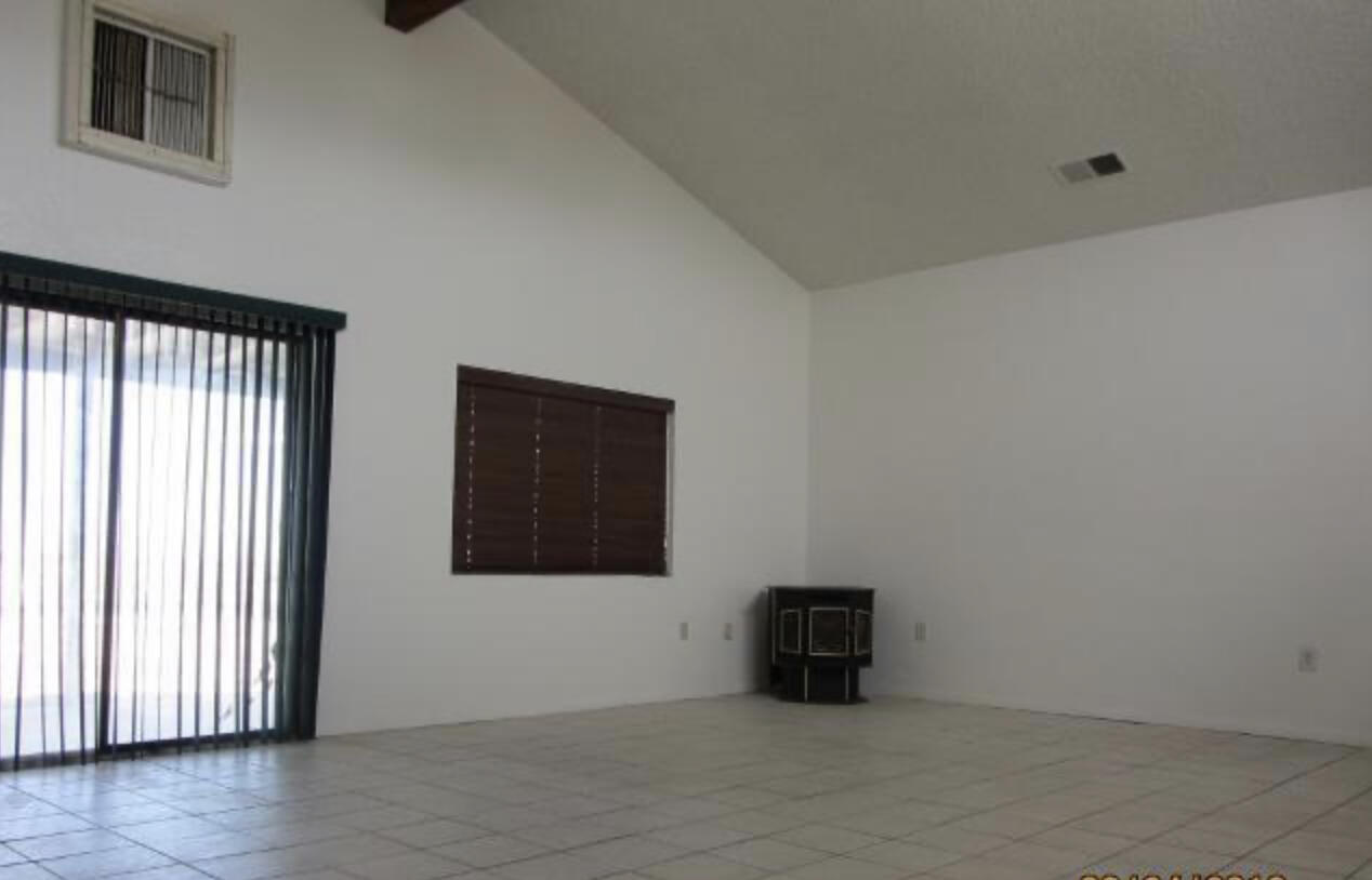48801 97th Street East Lancaster, CA 93535 - Photo 13 of 14 a view of a livingroom with an empty space and a window