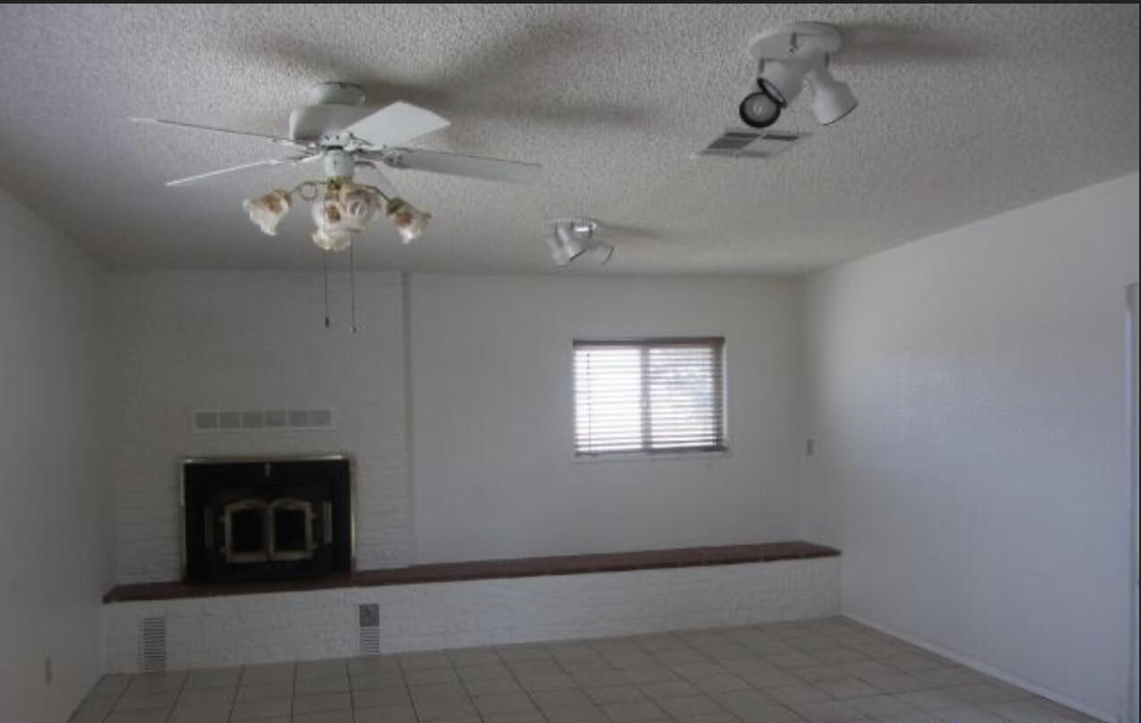 48801 97th Street East Lancaster, CA 93535 - Photo 14 of 14 an empty room with windows and fan