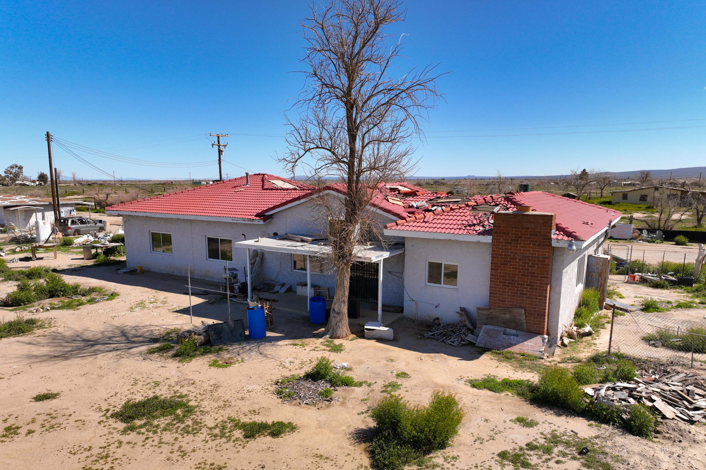 48801 97th Street East Lancaster, CA 93535 - Photo 2 of 14 a front view of a house with a yard