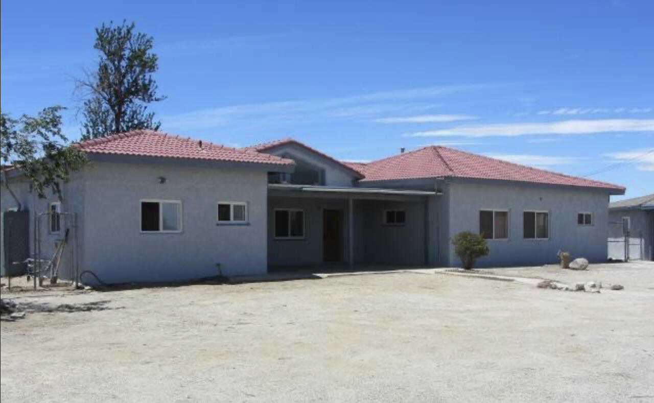 48801 97th Street East Lancaster, CA 93535 - Photo 9 of 14 a house with trees in the background