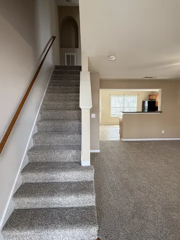 a view of entryway and hall with wooden floor