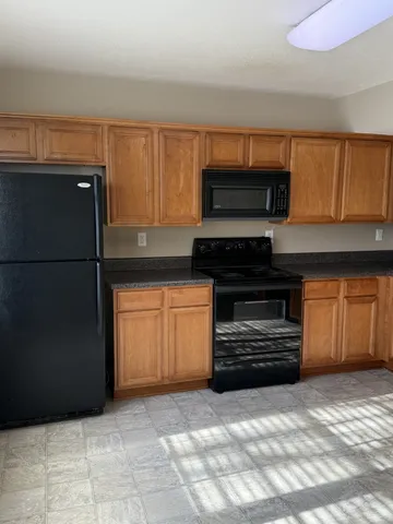 a kitchen with a refrigerator and a stove