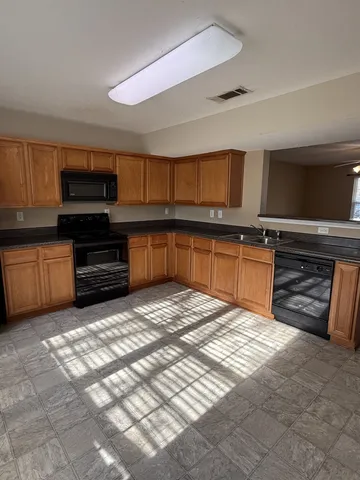 a kitchen with stainless steel appliances granite countertop a stove and a sink