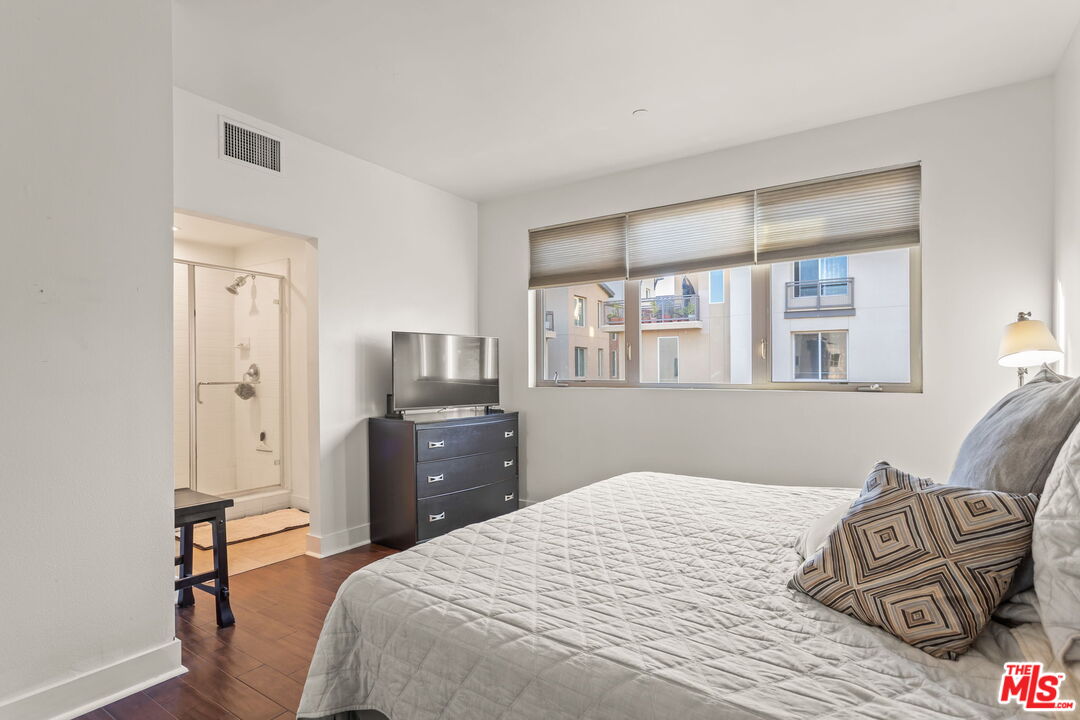 25 Delancy Irvine, CA 92612 - Photo 15 of 41 a bedroom with a bed and wooden floor