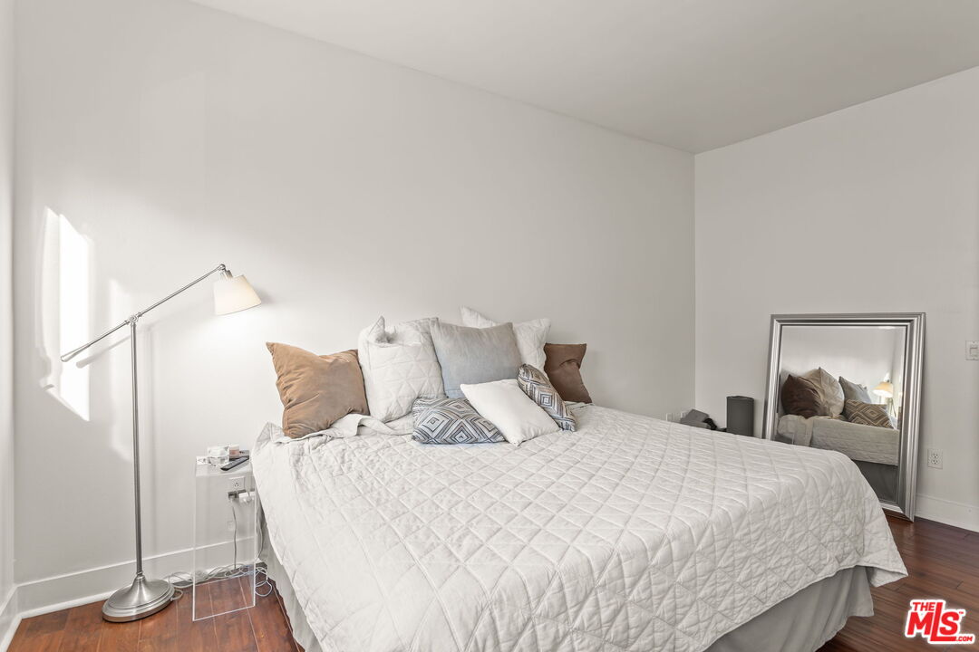 25 Delancy Irvine, CA 92612 - Photo 16 of 41 a bedroom with a bed and wooden floor