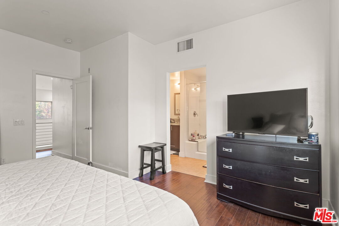 25 Delancy Irvine, CA 92612 - Photo 17 of 41 a bedroom with a bed and a flat screen tv