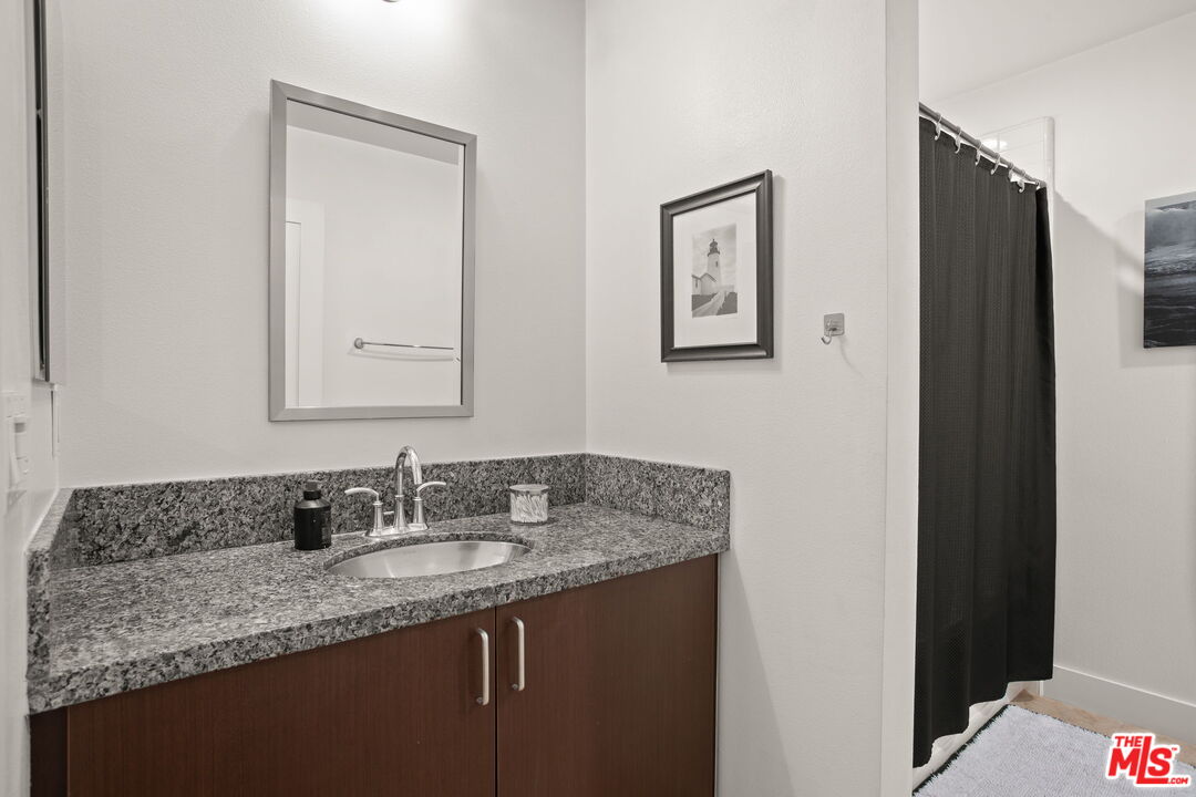 25 Delancy Irvine, CA 92612 - Photo 33 of 41 a bathroom with a granite countertop sink and a mirror