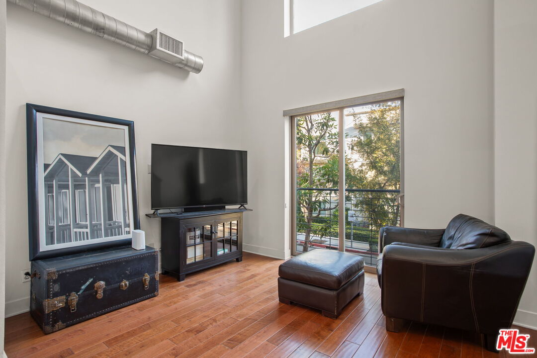 25 Delancy Irvine, CA 92612 - Photo 7 of 41 a living room with furniture and a flat screen tv
