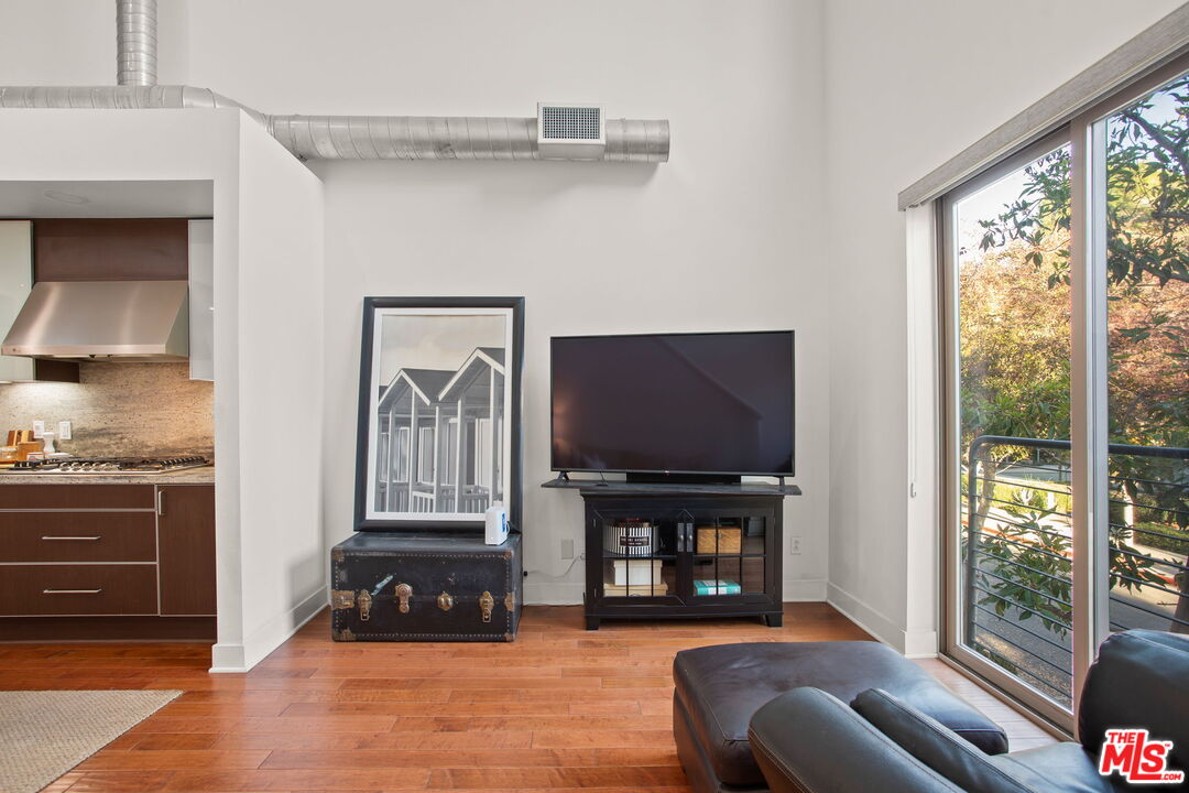 25 Delancy Irvine, CA 92612 - Photo 8 of 41 a living room with furniture a fireplace and a flat screen tv