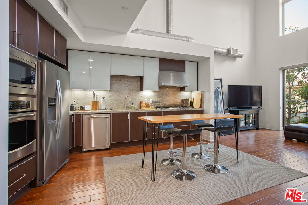 25 Delancy Irvine, CA 92612 - Photo 10 of 41 a kitchen with refrigerator cabinets and wooden floor