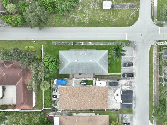 an aerial view of a house with a garden and a yard