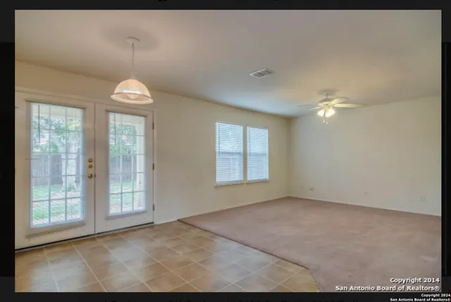 an empty room with windows and outdoor view