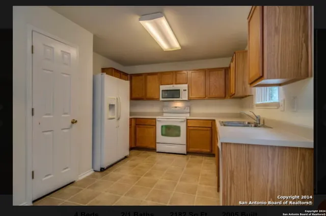 a kitchen with a refrigerator sink and stove