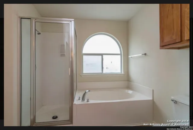 a bathroom with a bathtub and a shower