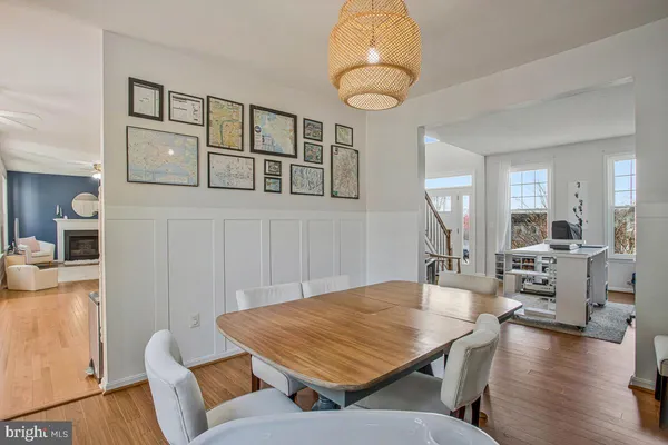 a living room with furniture a table and kitchen view