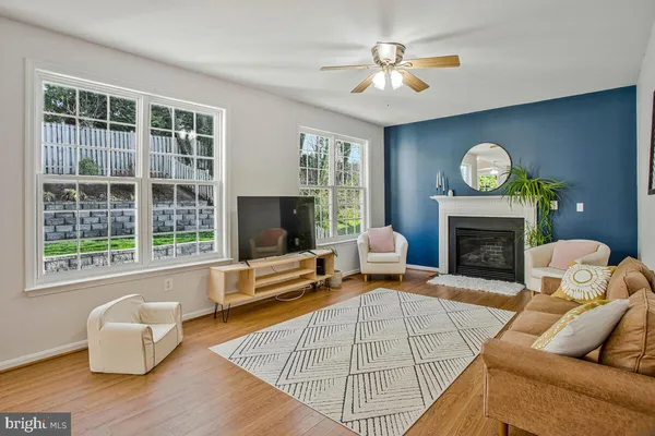 a living room with furniture a large window and a fireplace
