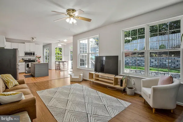 a living room with furniture and large windows