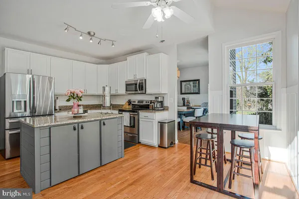 a kitchen with appliances cabinets and a counter top space