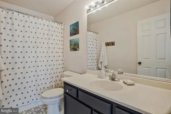 a bathroom with a sink toilet and a mirror