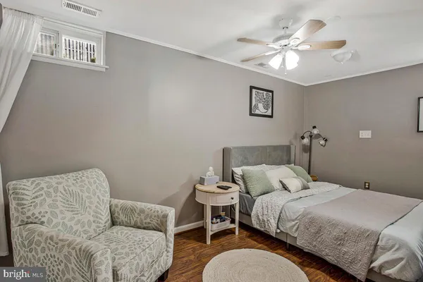 a bedroom with a bed couch and a window