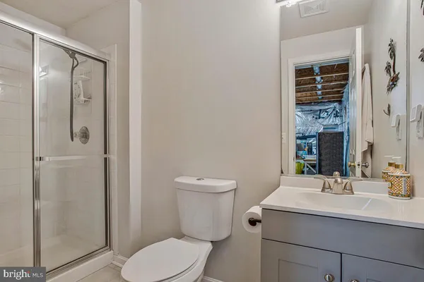 a bathroom with a toilet a sink and a mirror