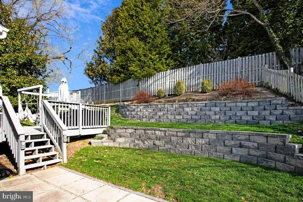 a view of a deck with a yard and wooden fence