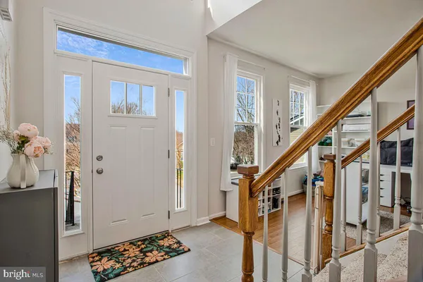a view of an entryway with wooden floor and stairs