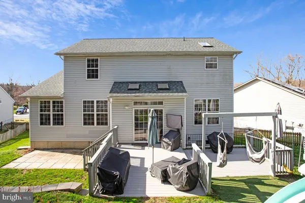 a view of a house with backyard porch and sitting area