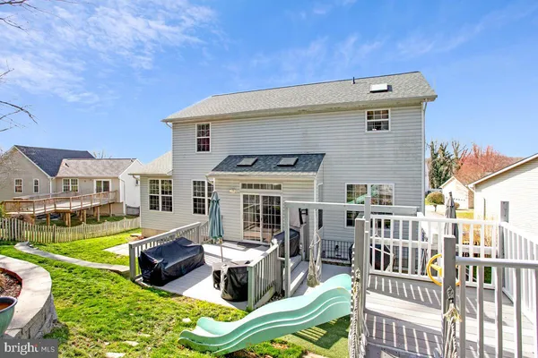 a view of a house with backyard porch and sitting area
