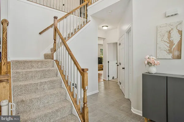 a view of a hallway with wooden floor and entryway