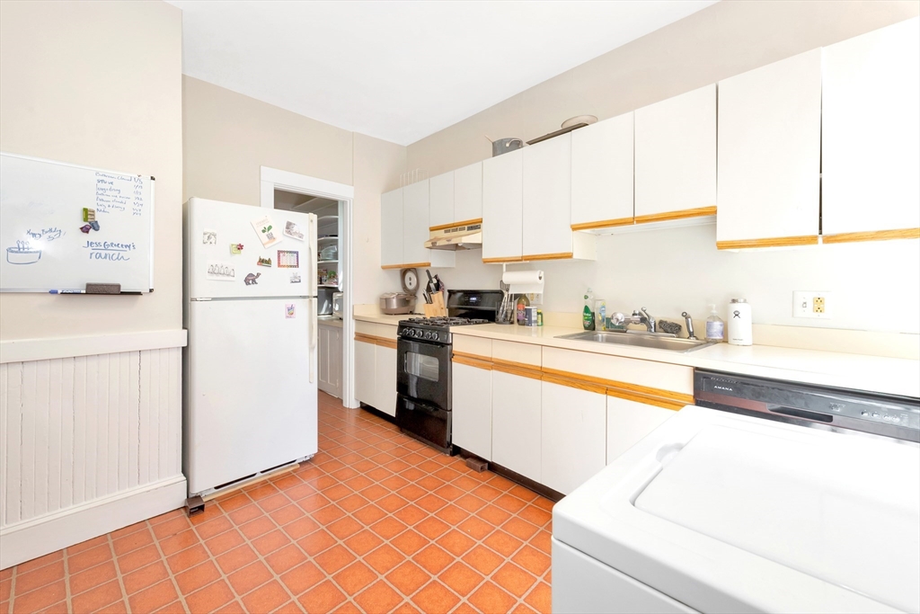 104 Strathmore Road Boston, MA 02135 - Photo 12 of 41 a kitchen with stainless steel appliances a refrigerator sink and cabinets