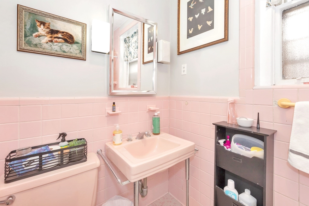 104 Strathmore Road Boston, MA 02135 - Photo 16 of 41 a bathroom with a sink and a stove with wooden floor