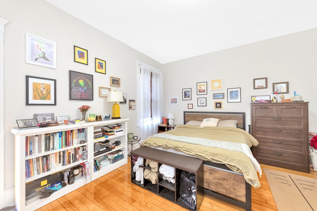 104 Strathmore Road Boston, MA 02135 - Photo 18 of 41 a bedroom with a bed and a book shelf