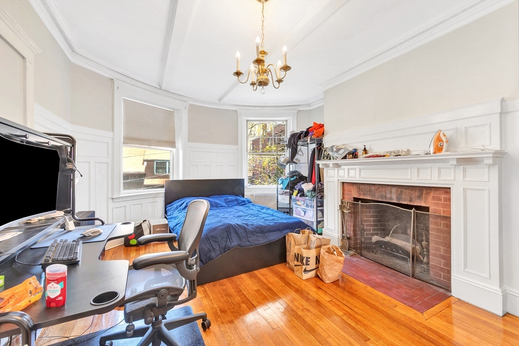 104 Strathmore Road Boston, MA 02135 - Photo 23 of 41 a bedroom with furniture and a fireplace