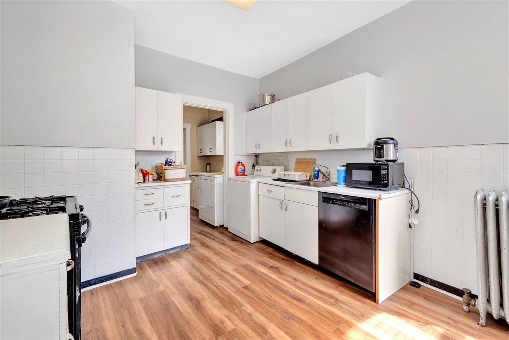 104 Strathmore Road Boston, MA 02135 - Photo 25 of 41 a kitchen with cabinets a sink and appliances