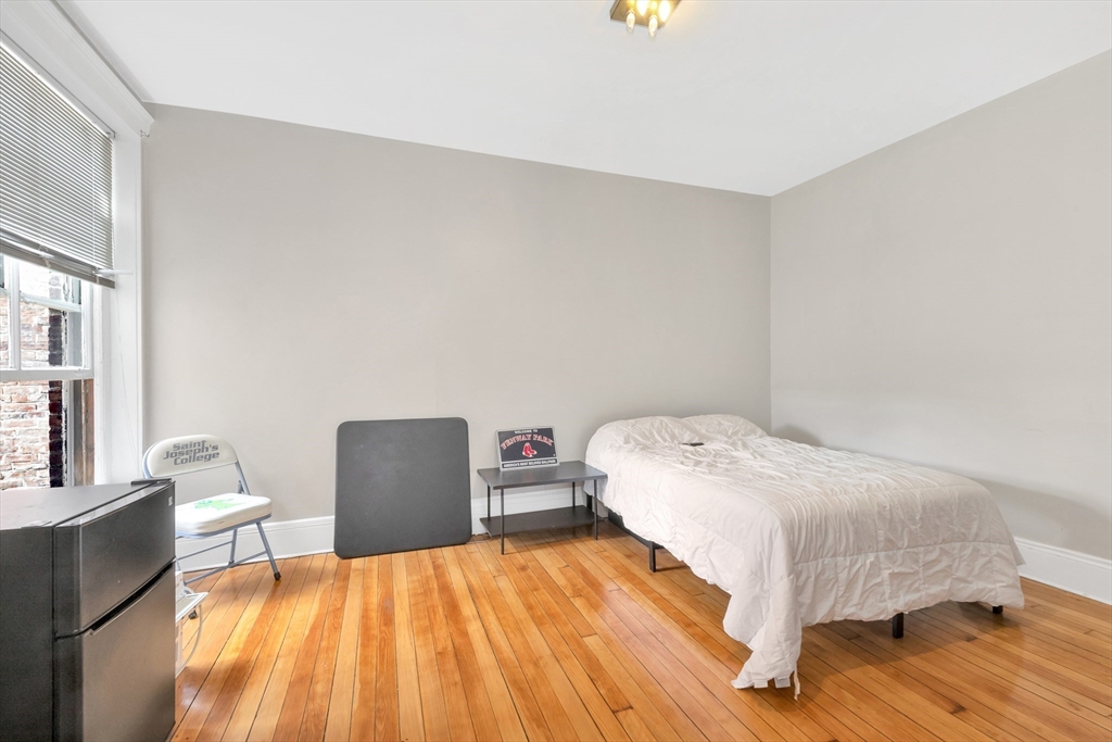 104 Strathmore Road Boston, MA 02135 - Photo 26 of 41 a bedroom with a bed and chair