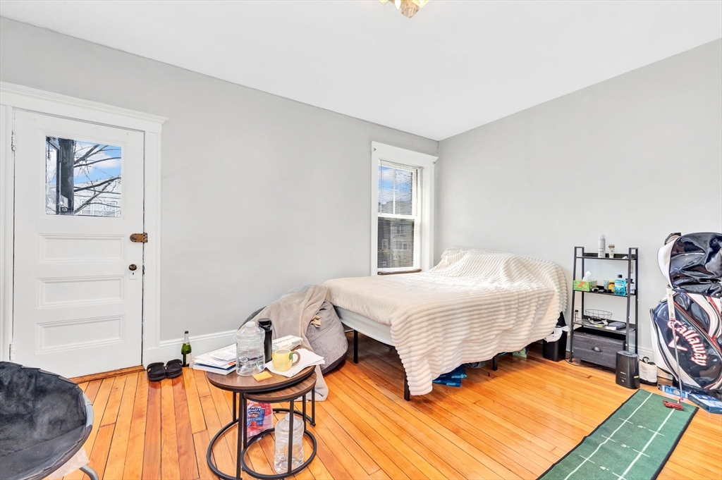 104 Strathmore Road Boston, MA 02135 - Photo 29 of 41 a bedroom with bed and a window