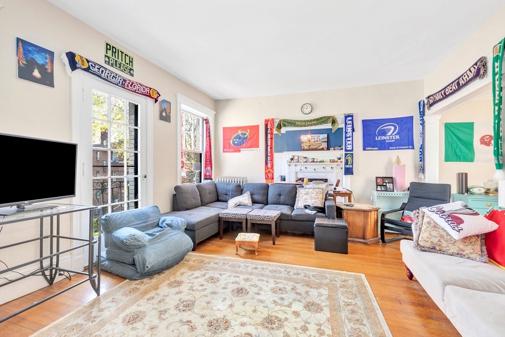 104 Strathmore Road Boston, MA 02135 - Photo 32 of 41 a living room with furniture and a flat screen tv