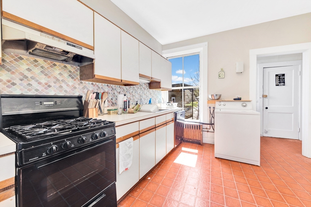104 Strathmore Road Boston, MA 02135 - Photo 35 of 41 a kitchen with stainless steel appliances a sink dishwasher stove and white cabinets