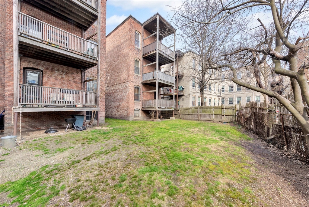 104 Strathmore Road Boston, MA 02135 - Photo 41 of 41 a view of a house with a yard and wooden fence