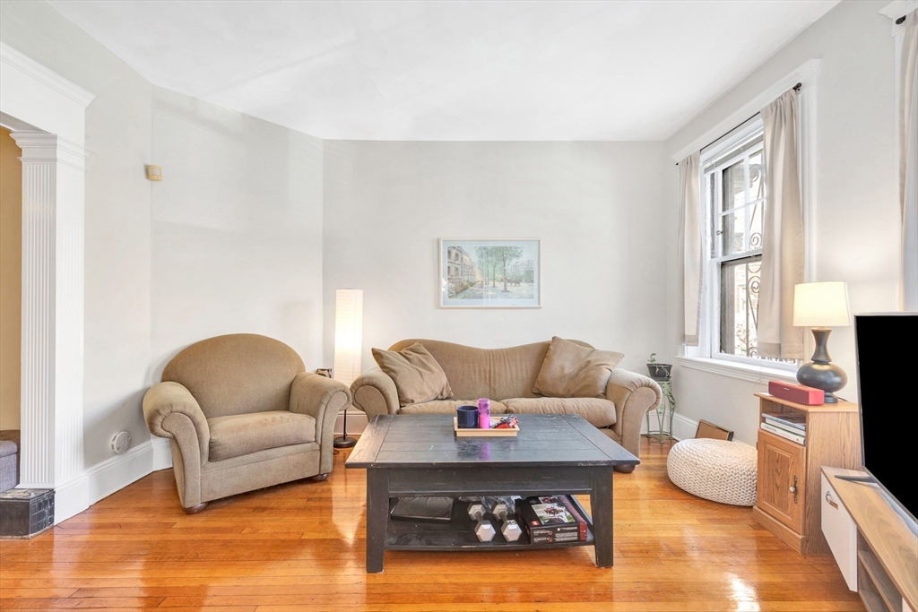 104 Strathmore Road Boston, MA 02135 - Photo 6 of 41 a living room with furniture and a flat screen tv