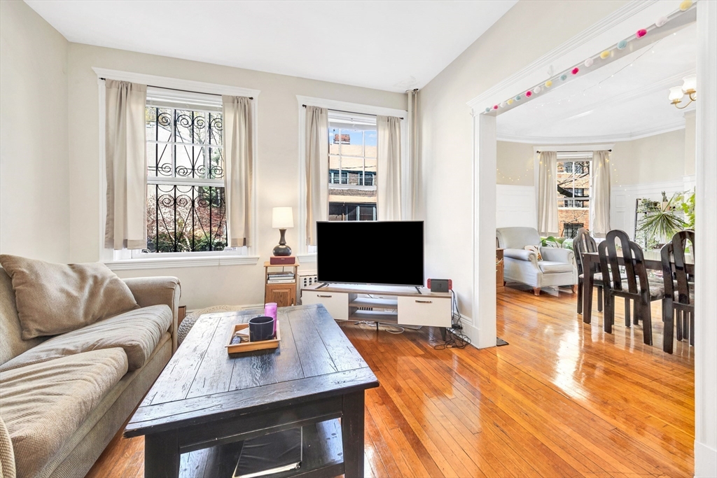 104 Strathmore Road Boston, MA 02135 - Photo 7 of 41 a living room with furniture and wooden floor