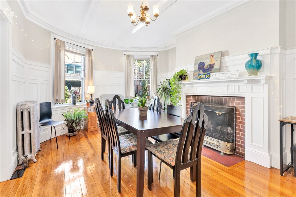 104 Strathmore Road Boston, MA 02135 - Photo 9 of 41 a dining room with furniture a fireplace and wooden floor