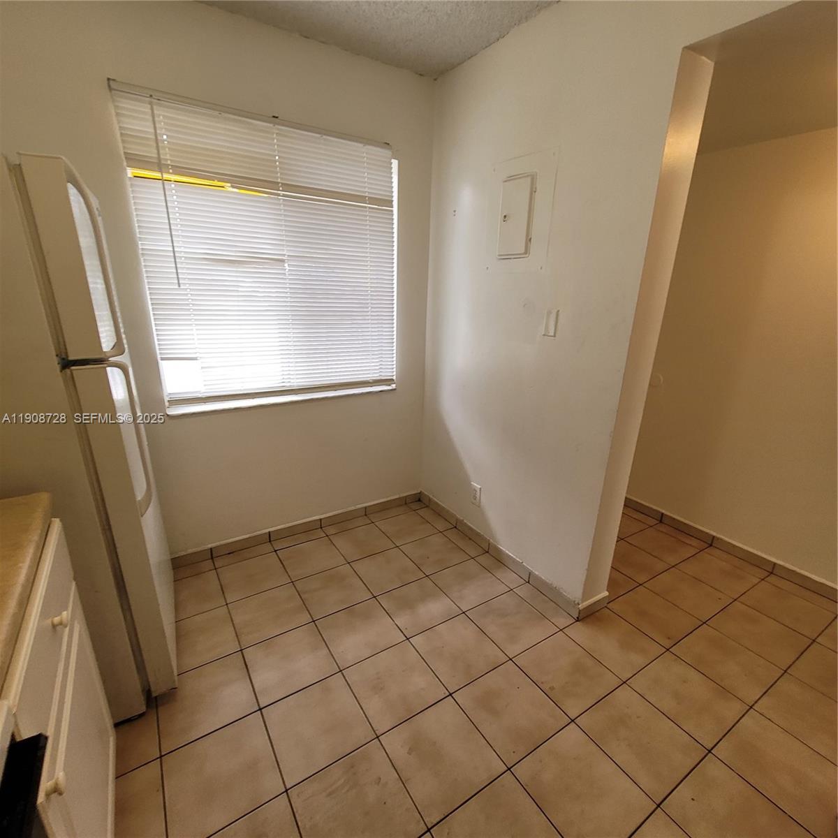 8540 Sherman Circle North, Unit 101 Miramar, FL 33025 - Photo 13 of 36 a view of an empty room and window