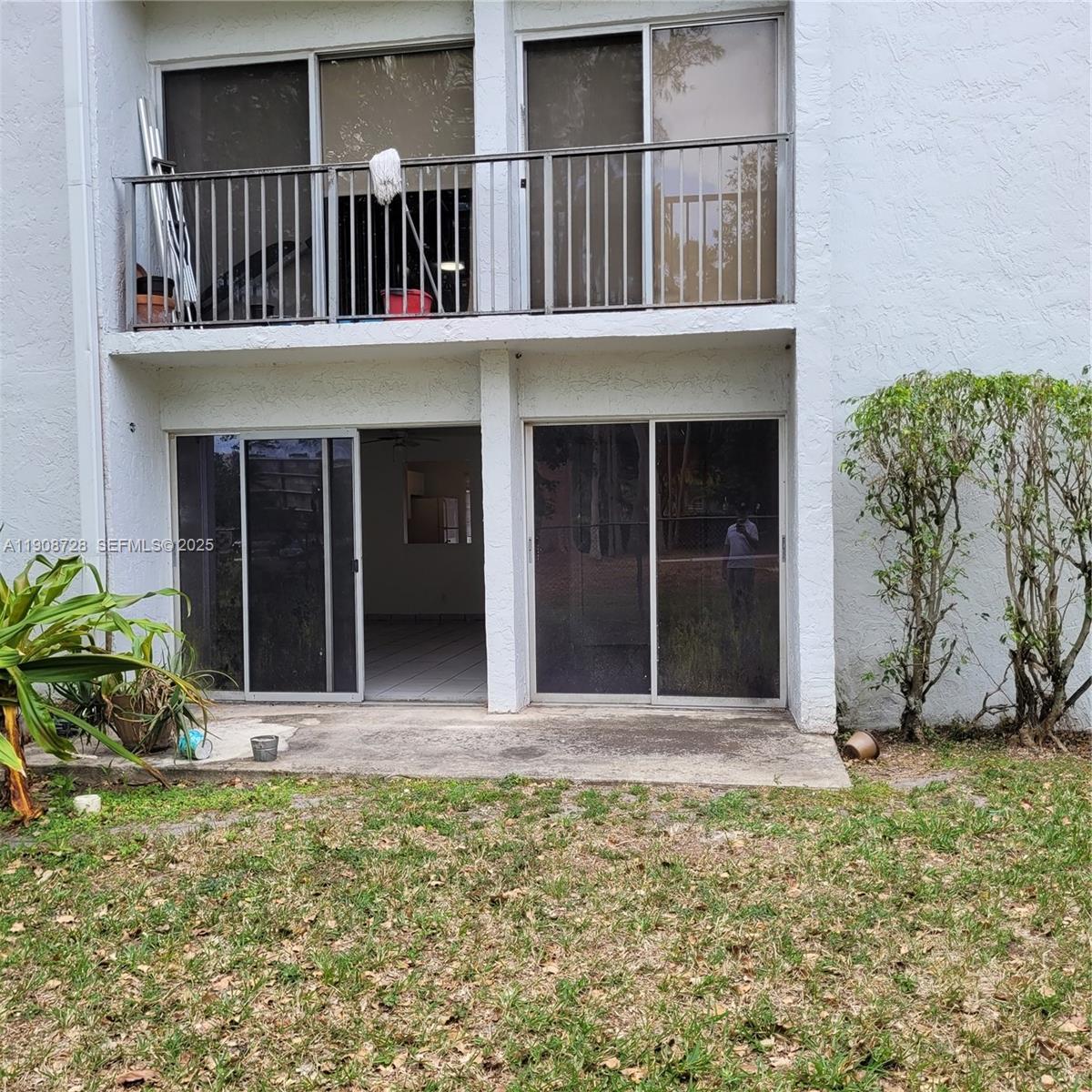 8540 Sherman Circle North, Unit 101 Miramar, FL 33025 - Photo 20 of 36 a view of white house with large windows and plants