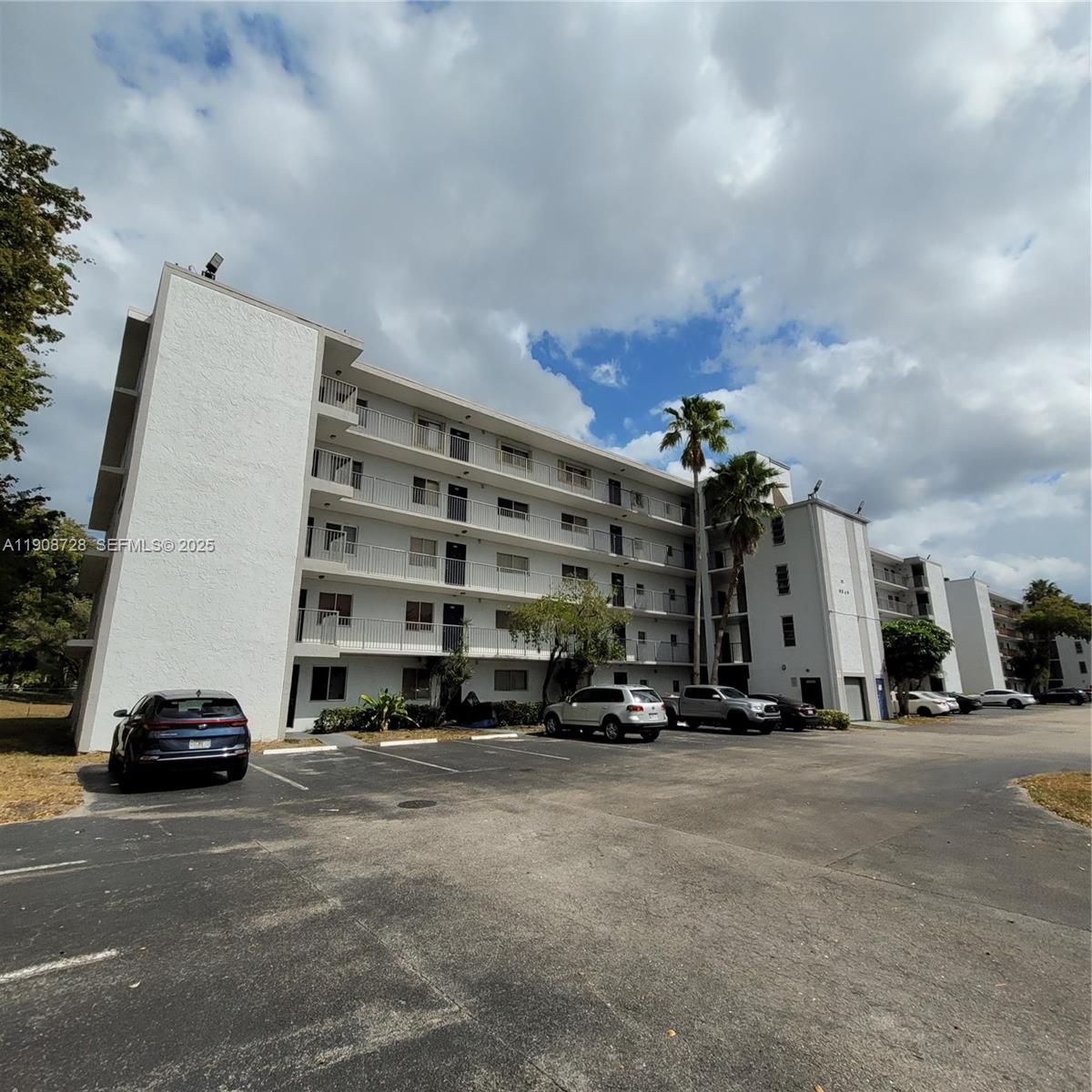 8540 Sherman Circle North, Unit 101 Miramar, FL 33025 - Photo 2 of 36 a view of car parked in front of a building