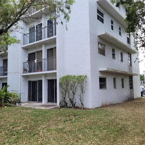 a view of a building with a yard